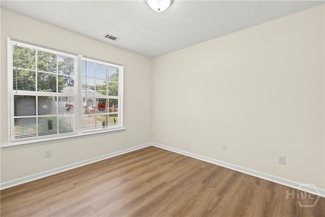 303 Aspen, Rincon, GA 31326 - unfurnished room featuring wood finished floors, baseboards, and a textured ceiling