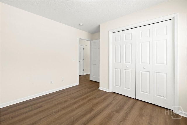 303 Aspen, Rincon, GA 31326 - unfurnished bedroom featuring wood finished floors, baseboards, a closet, and a textured ceiling