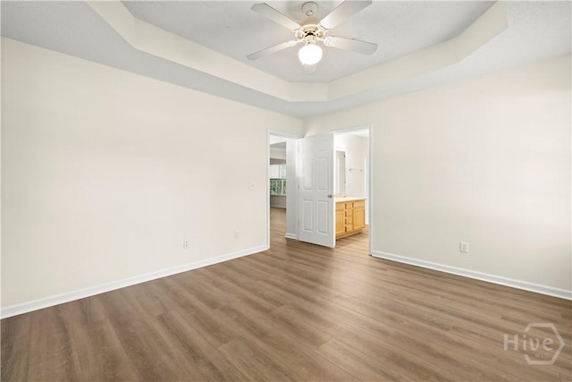 303 Aspen, Rincon, GA 31326 - spare room featuring baseboards, wood finished floors, a raised ceiling, and ceiling fan