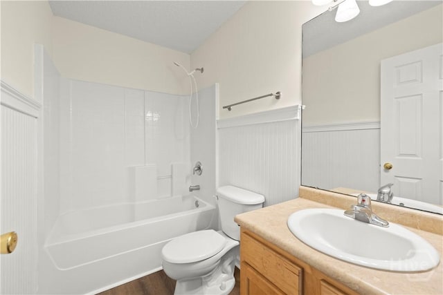 303 Aspen, Rincon, GA 31326 - bathroom with toilet, wainscoting, vanity, washtub / shower combination, and wood finished floors