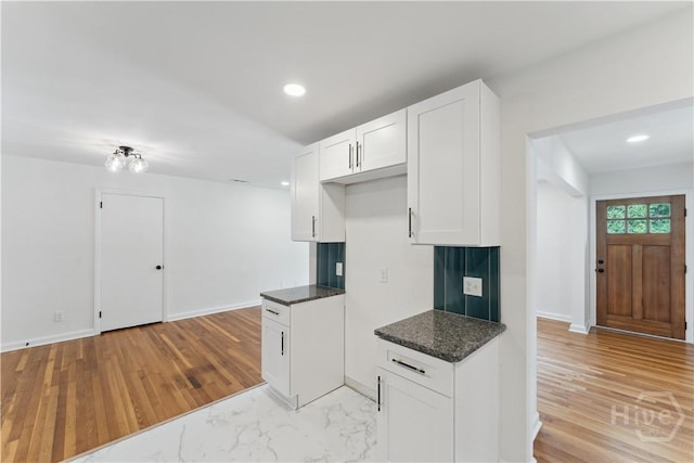 2310 Toussaint Ave, Savannah, GA 31404 - kitchen featuring white cabinetry, recessed lighting, baseboards, light wood-style flooring, and dark stone counters