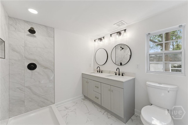 2310 Toussaint Ave, Savannah, GA 31404 - bathroom with marble look tiles, toilet, double vanity, baseboards, and a tile shower