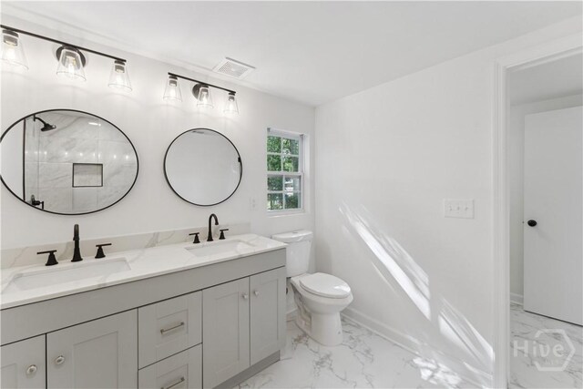 2310 Toussaint Ave, Savannah, GA 31404 - full bathroom featuring marble look tiles, double vanity, toilet, and a shower