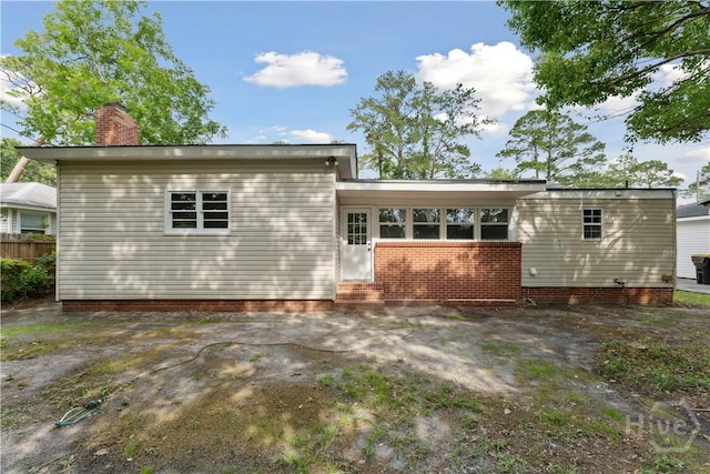 2310 Toussaint Ave, Savannah, GA 31404 - rear view of property with a chimney and entry steps