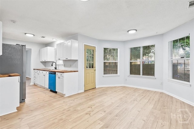 17 Walthour Cv, Savannah, GA 31410 - kitchen with freestanding refrigerator, white cabinets, light wood-style floors, and dishwasher