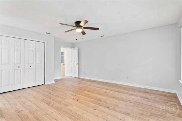 17 Walthour Cv, Savannah, GA 31410 - unfurnished bedroom with baseboards, light wood finished floors, a closet, and a textured ceiling