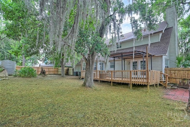 17 Walthour Cv, Savannah, GA 31410 - back of house with a shingled roof, a deck, and a chimney