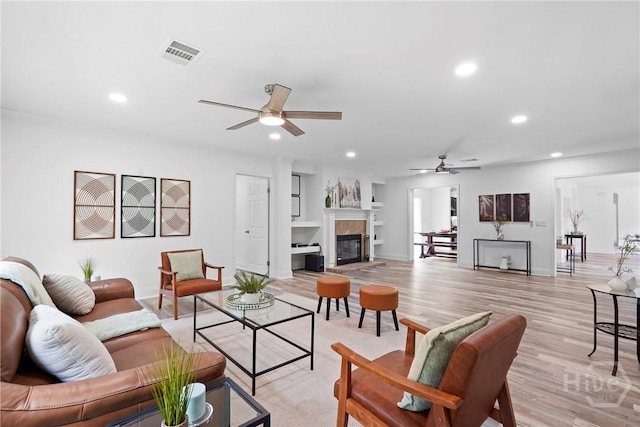 550 Brogdon Rd, Guyton, GA 31312 - living area featuring a ceiling fan, recessed lighting, light wood-style floors, baseboards, and a glass covered fireplace