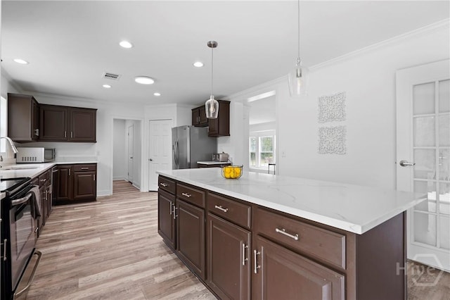 550 Brogdon Rd, Guyton, GA 31312 - kitchen with freestanding refrigerator, dark brown cabinetry, a sink, electric range, and light wood-style floors
