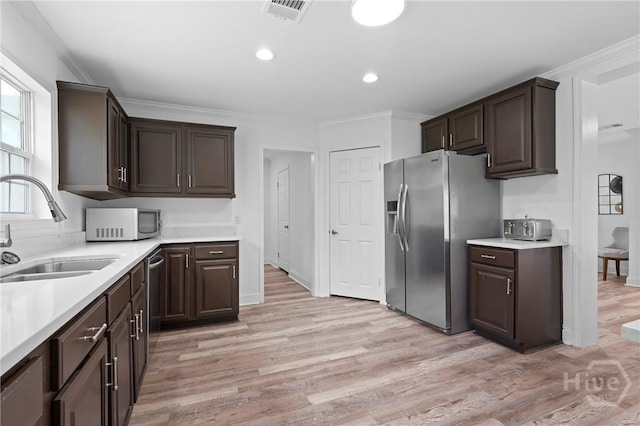 550 Brogdon Rd, Guyton, GA 31312 - kitchen featuring stainless steel appliances, a sink, dark brown cabinets, light countertops, and light wood-style floors