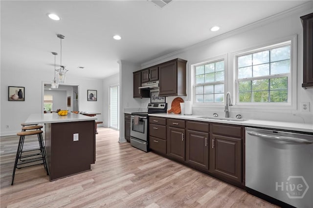 550 Brogdon Rd, Guyton, GA 31312 - kitchen featuring appliances with stainless steel finishes, a sink, light countertops, dark brown cabinets, and ventilation hood