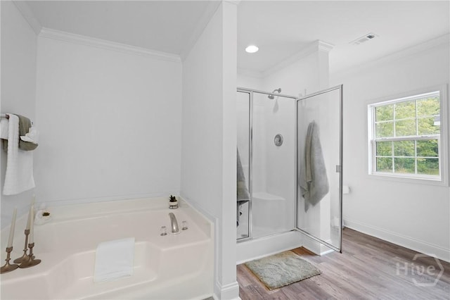 550 Brogdon Rd, Guyton, GA 31312 - bathroom featuring ornamental molding, a stall shower, a bath, wood finished floors, and baseboards