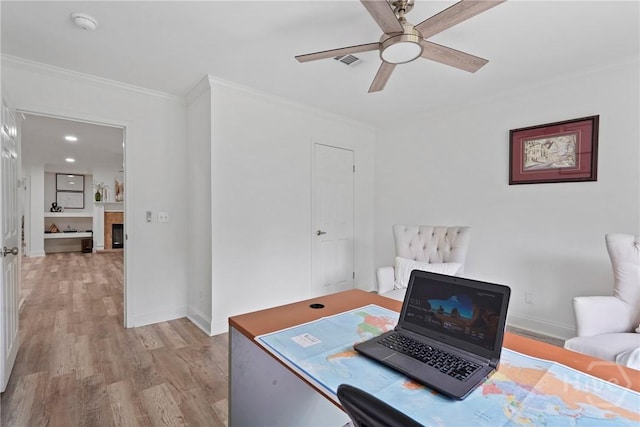 550 Brogdon Rd, Guyton, GA 31312 - home office featuring crown molding, light wood-style floors, a ceiling fan, a fireplace, and baseboards