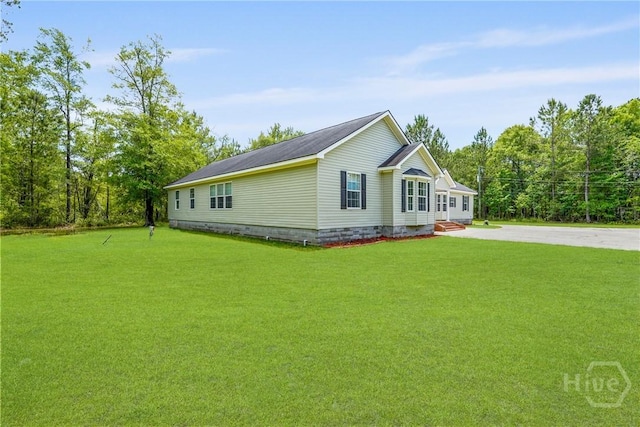 550 Brogdon Rd, Guyton, GA 31312 - view of property exterior featuring a lawn, driveway, and crawl space