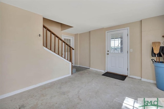 1056 Fiddler Trce, Townsend, GA 31331 - entryway with baseboards, stairs, and unfinished concrete flooring