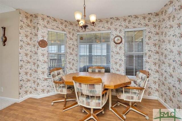 1056 Fiddler Trce, Townsend, GA 31331 - dining area with wallpapered walls, a chandelier, baseboards, and wood finished floors