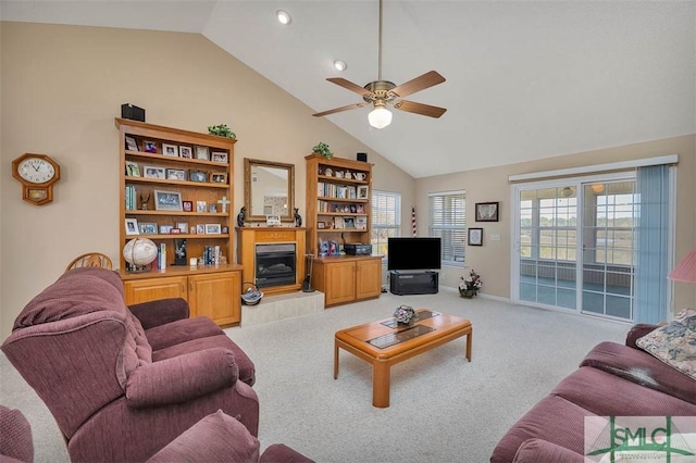 1056 Fiddler Trce, Townsend, GA 31331 - living room with ceiling fan, light carpet, a tiled fireplace, high vaulted ceiling, and baseboards