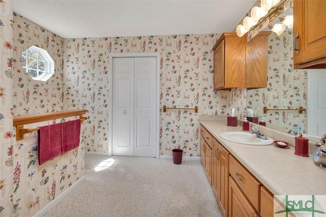 1056 Fiddler Trce, Townsend, GA 31331 - bathroom with wallpapered walls, vanity, baseboards, and carpet floors