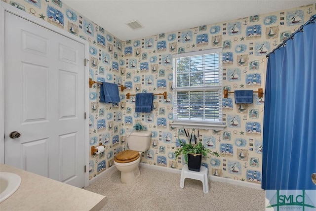 1056 Fiddler Trce, Townsend, GA 31331 - bathroom with baseboards, wallpapered walls, toilet, and vanity