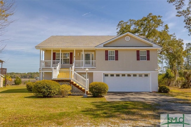 1056 Fiddler Trce, Townsend, GA 31331 - view of front facade with stairway, a garage, driveway, a porch, and a front yard