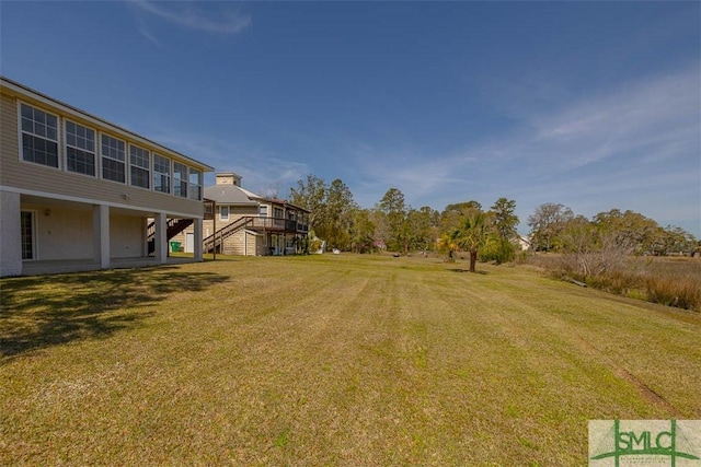 1056 Fiddler Trce, Townsend, GA 31331 - view of green lawn featuring stairway and a wooden deck
