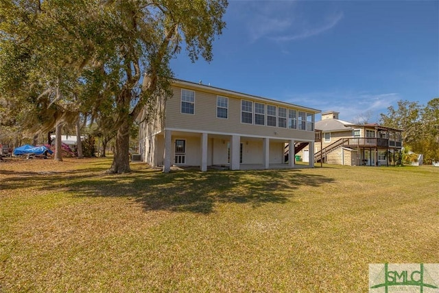 1056 Fiddler Trce, Townsend, GA 31331 - rear view of property with stairs and a yard