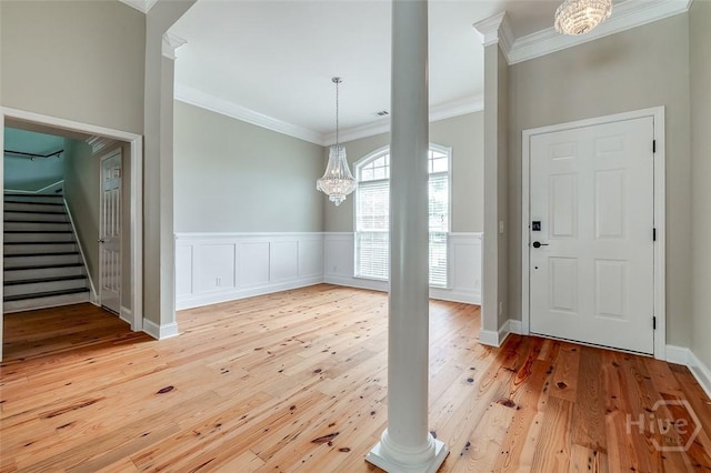 428 Roberts Way, Rincon, GA 31326 - entryway featuring ornamental molding, light wood finished floors, a chandelier, stairway, and a wainscoted wall
