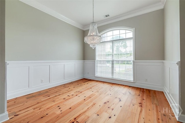 428 Roberts Way, Rincon, GA 31326 - unfurnished dining area with a chandelier, ornamental molding, light wood finished floors, and wainscoting