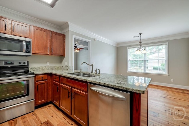 428 Roberts Way, Rincon, GA 31326 - kitchen featuring appliances with stainless steel finishes, a sink, a peninsula, light wood-type flooring, and light stone countertops