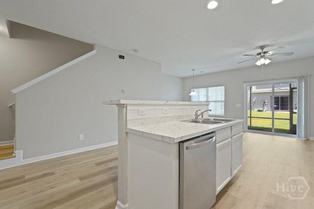 10 Brown Thrasher Ct, Port Wentworth, GA 31407 - kitchen featuring dishwasher, a sink, light wood-type flooring, white cabinets, and baseboards