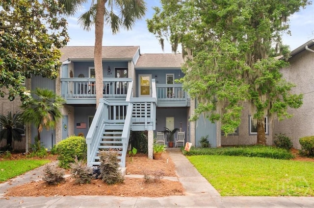 226 Bull River Bluff Dr, Savannah, GA 31410 - view of front of property with a front lawn, stairway, and a shingled roof