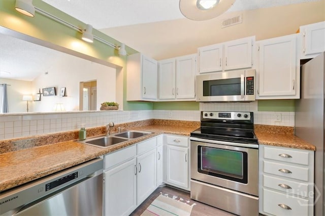 226 Bull River Bluff Dr, Savannah, GA 31410 - kitchen featuring stainless steel appliances, white cabinets, and backsplash