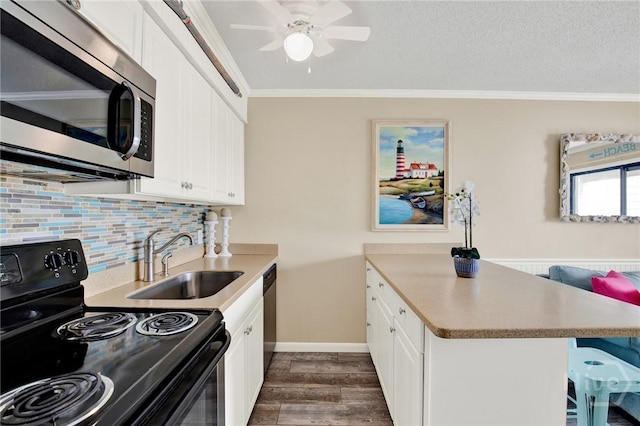 1217 Bay St Unit 105B, Tybee Island, GA 31328 - kitchen featuring black / electric stove, stainless steel microwave, dark wood-style flooring, crown molding, and backsplash