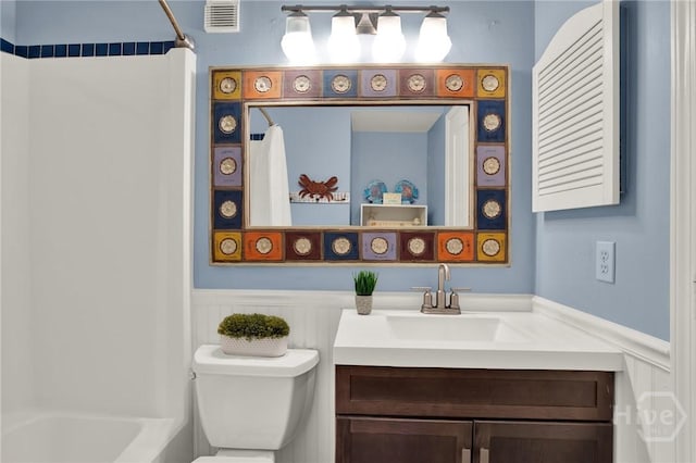 1217 Bay St Unit 105B, Tybee Island, GA 31328 - bathroom with a wainscoted wall, vanity, and  shower combination
