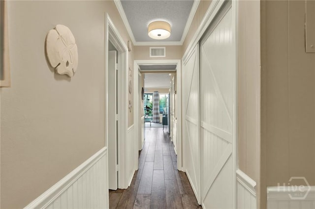 1217 Bay St Unit 105B, Tybee Island, GA 31328 - corridor with ornamental molding, a decorative wall, dark wood-style floors, and wainscoting