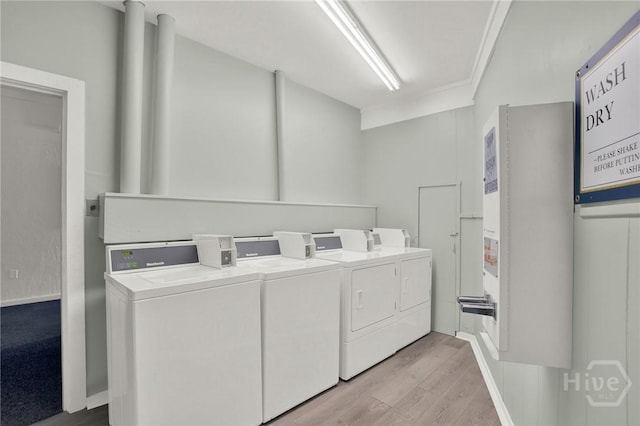 1217 Bay St Unit 105B, Tybee Island, GA 31328 - community laundry with separate washer and dryer and light wood-style flooring