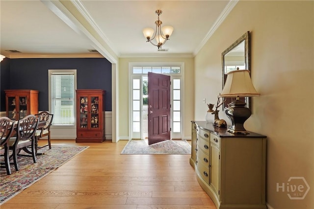 8813 Whitefield Ave, Savannah, GA 31406 - entrance foyer with a chandelier, ornamental molding, light wood-type flooring, and baseboards