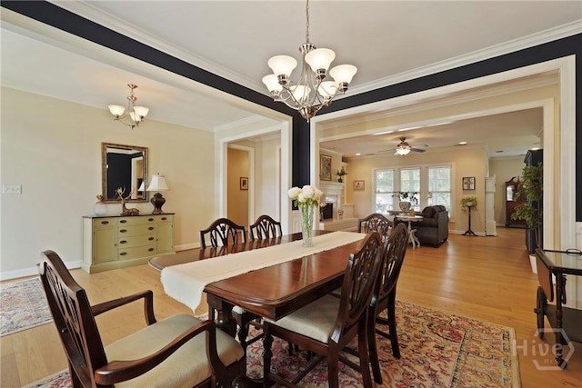 8813 Whitefield Ave, Savannah, GA 31406 - dining area with a chandelier, light wood-style floors, crown molding, baseboards, and ceiling fan