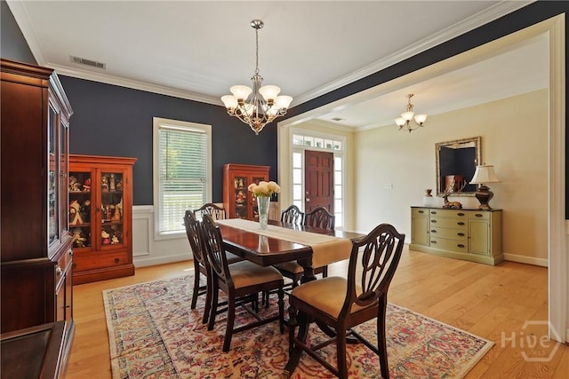8813 Whitefield Ave, Savannah, GA 31406 - dining room featuring a chandelier, light wood-style floors, and crown molding