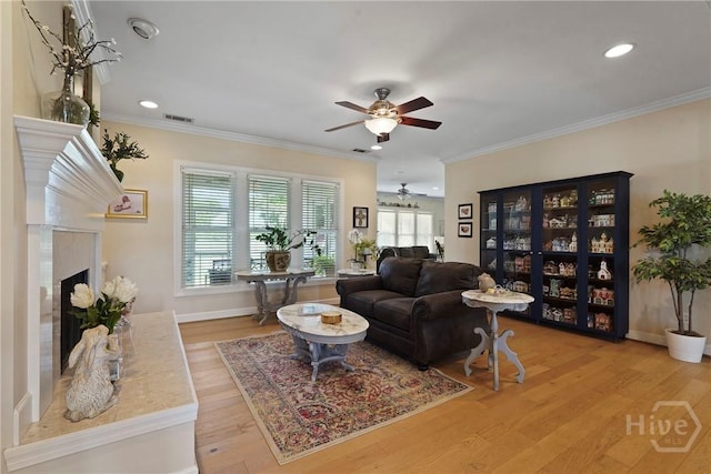 8813 Whitefield Ave, Savannah, GA 31406 - living area featuring a ceiling fan, a fireplace with raised hearth, ornamental molding, light wood-type flooring, and recessed lighting