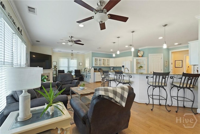 8813 Whitefield Ave, Savannah, GA 31406 - living area featuring recessed lighting, ceiling fan, ornamental molding, and light wood-type flooring
