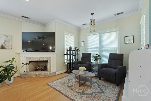 8813 Whitefield Ave, Savannah, GA 31406 - living room featuring wood finished floors, baseboards, a stone fireplace, and ornamental molding