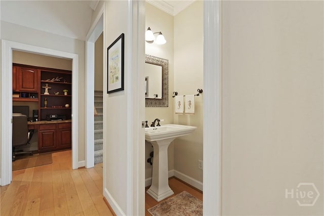 8813 Whitefield Ave, Savannah, GA 31406 - corridor with light wood-style flooring, a desk, crown molding, stairway, and baseboards