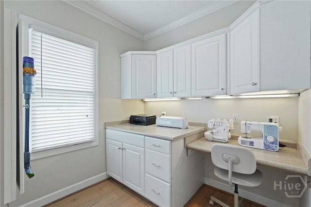 8813 Whitefield Ave, Savannah, GA 31406 - home office featuring built in study area, light wood-style floors, ornamental molding, and baseboards
