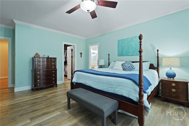 8813 Whitefield Ave, Savannah, GA 31406 - bedroom featuring a spacious closet, crown molding, wood finished floors, baseboards, and ensuite bathroom