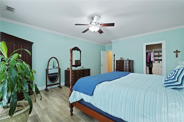 8813 Whitefield Ave, Savannah, GA 31406 - bedroom with ornamental molding, light wood-style floors, a spacious closet, ceiling fan, and baseboards
