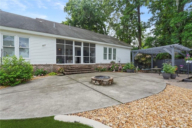 8813 Whitefield Ave, Savannah, GA 31406 - rear view of property featuring an outdoor fire pit, a pergola, a patio area, and brick siding