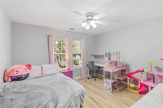 67 Oak Side Ct, Richmond Hill, GA 31324 - bedroom with wood finished floors, a desk, and a ceiling fan