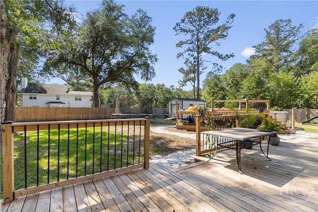 67 Oak Side Ct, Richmond Hill, GA 31324 - wooden deck with outdoor dining area and a trampoline