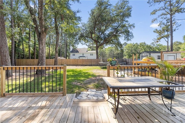 67 Oak Side Ct, Richmond Hill, GA 31324 - wooden terrace with a trampoline and outdoor dining area